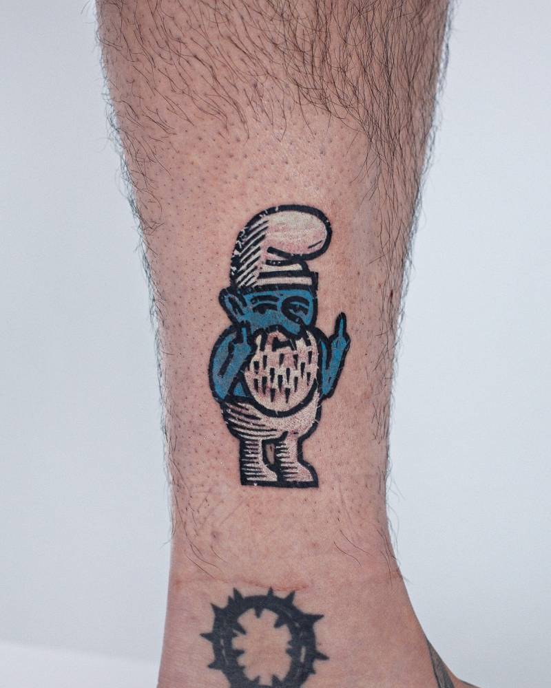 Smurf gnome tattoo located on the ankle, pop art style.