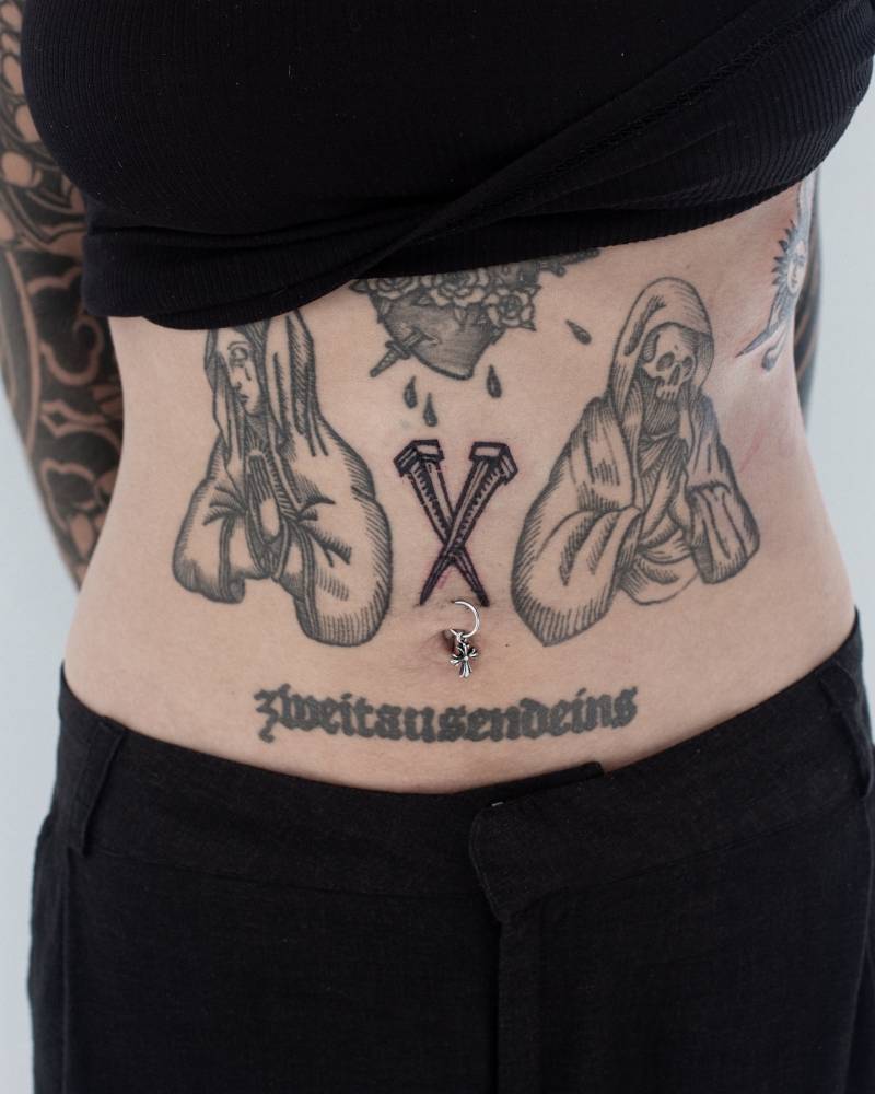 Nails tattoo in blackwork style placed on the stomach.