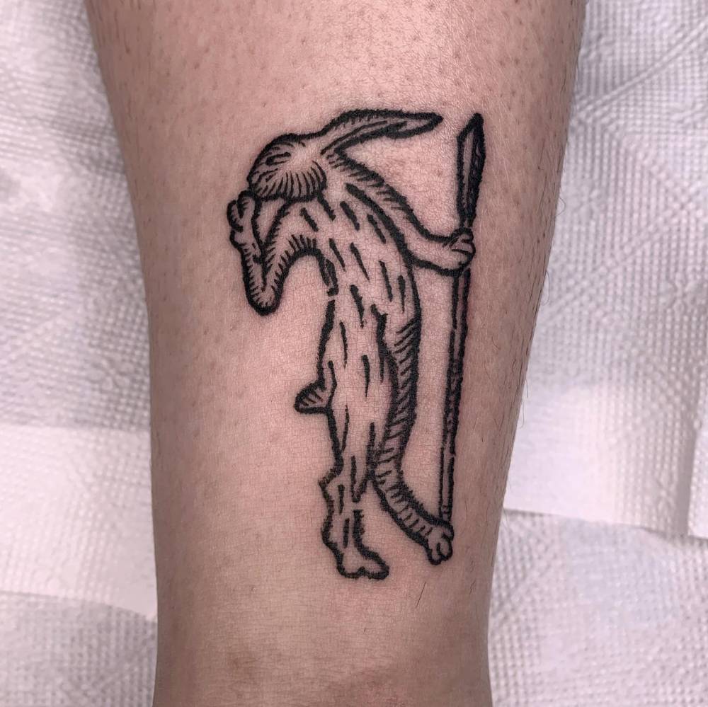 Hare tattoo in engraving style located on the wrist.