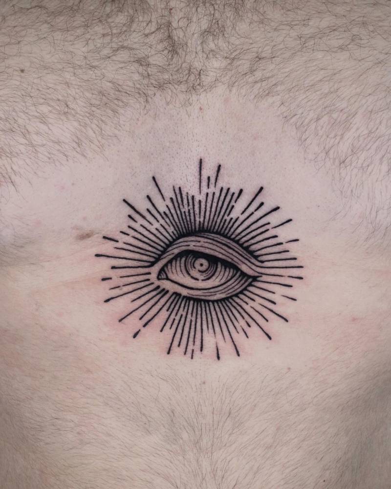 Engraving style eye tattoo placed on the sternum.