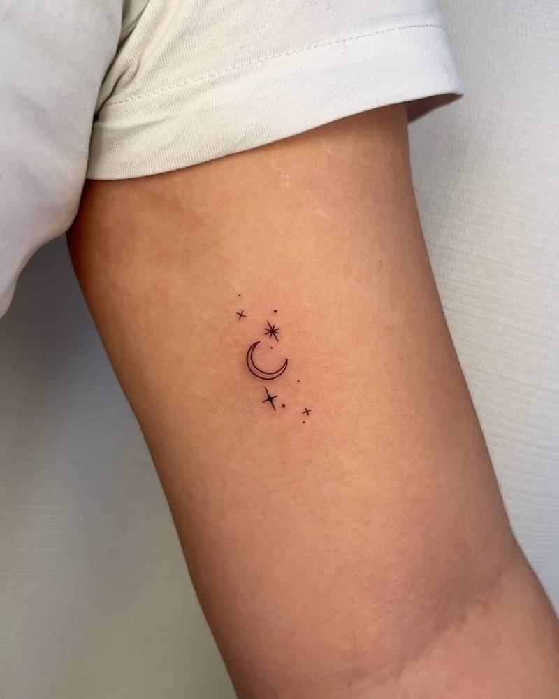 Moon and stars tattoo placed on the inner arm, minimalistic style.