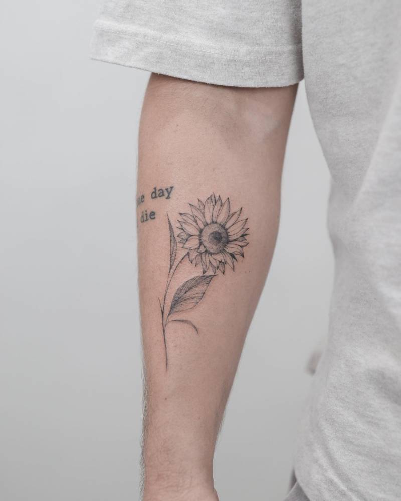 Sunflower tattoo located on the inner forearm, illustrative style.