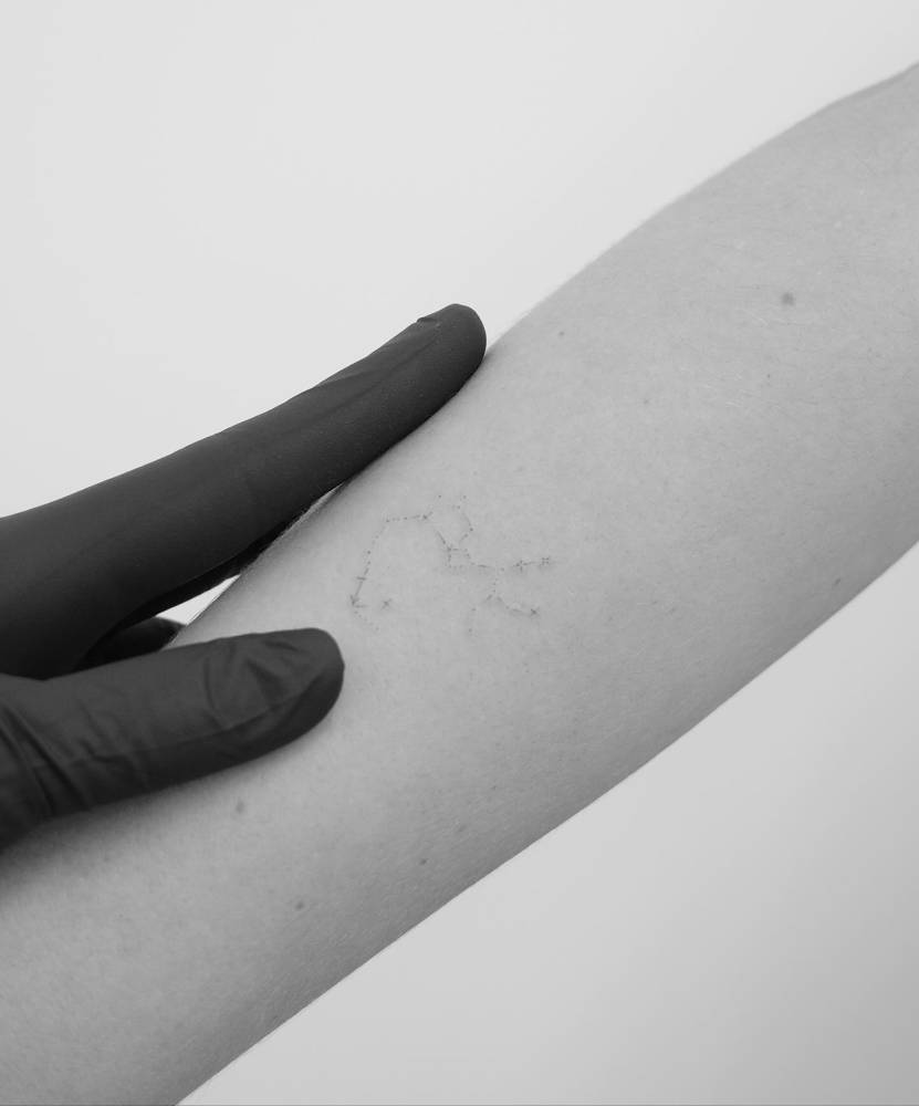 Minimalistic style Sagittarius constellation tattoo located on the inner forearm.