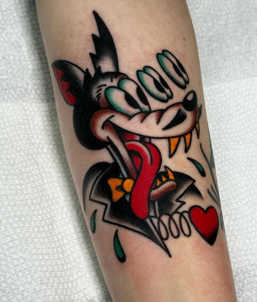 Wolf portrait tattoo in traditional style located on the inner forearm.