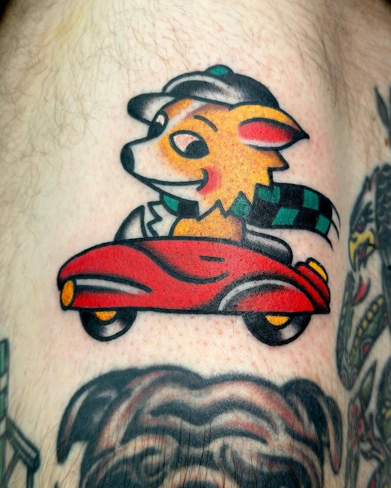 Driver fox tattoo located on the thigh, done in traditional style.