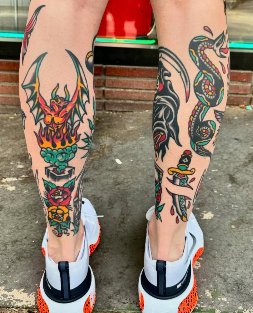 Devil and dagger tattoos in traditional style located on the calf and achilles.