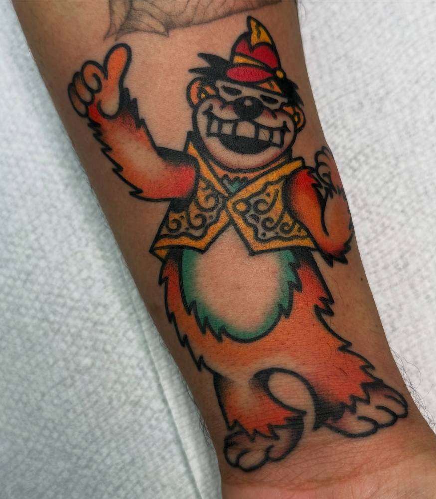 Bingo from 'The Banana Splits' tattooed on the wrist, traditional style.