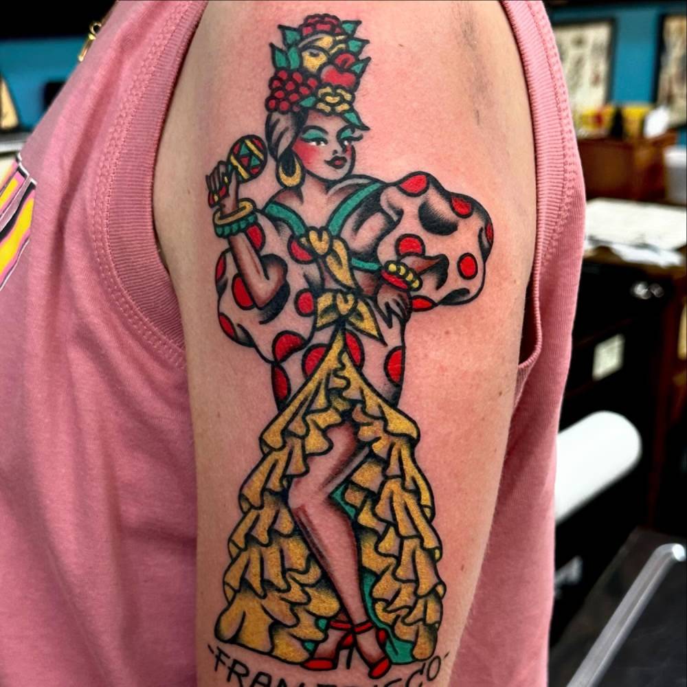 Traditional style Carmen Miranda tattoo located on the upper arm.