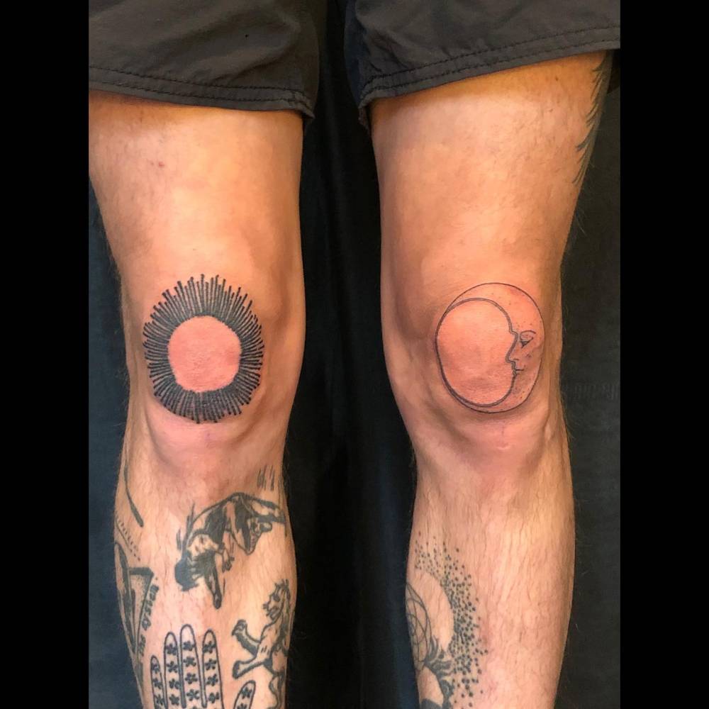 Illustrative style individual matching sun and moon tattoo located on the knees.