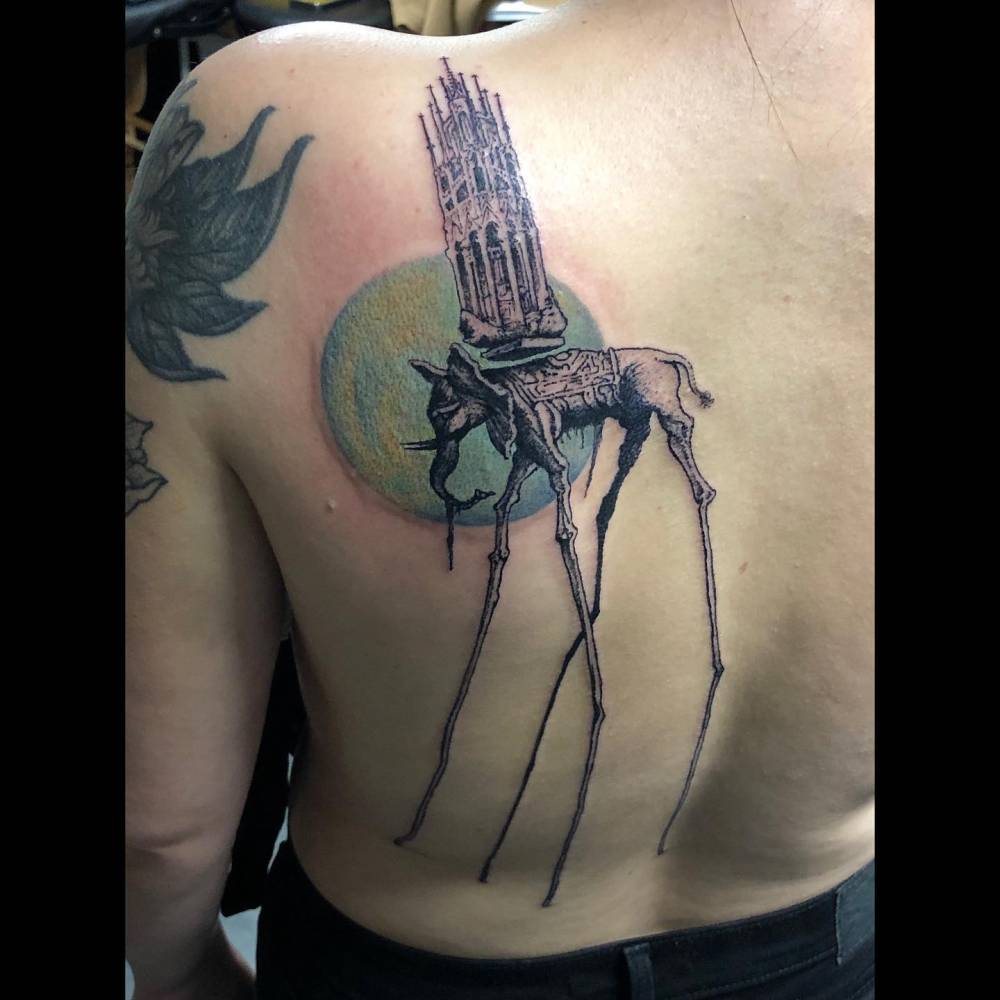 Dali's 'The Elephants' tattoo located on the back.