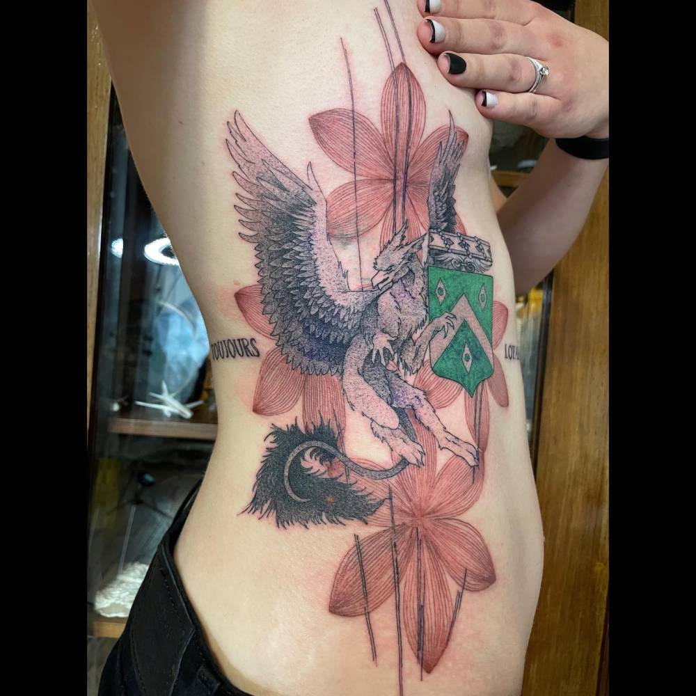 Graphic style family crest tattoo.