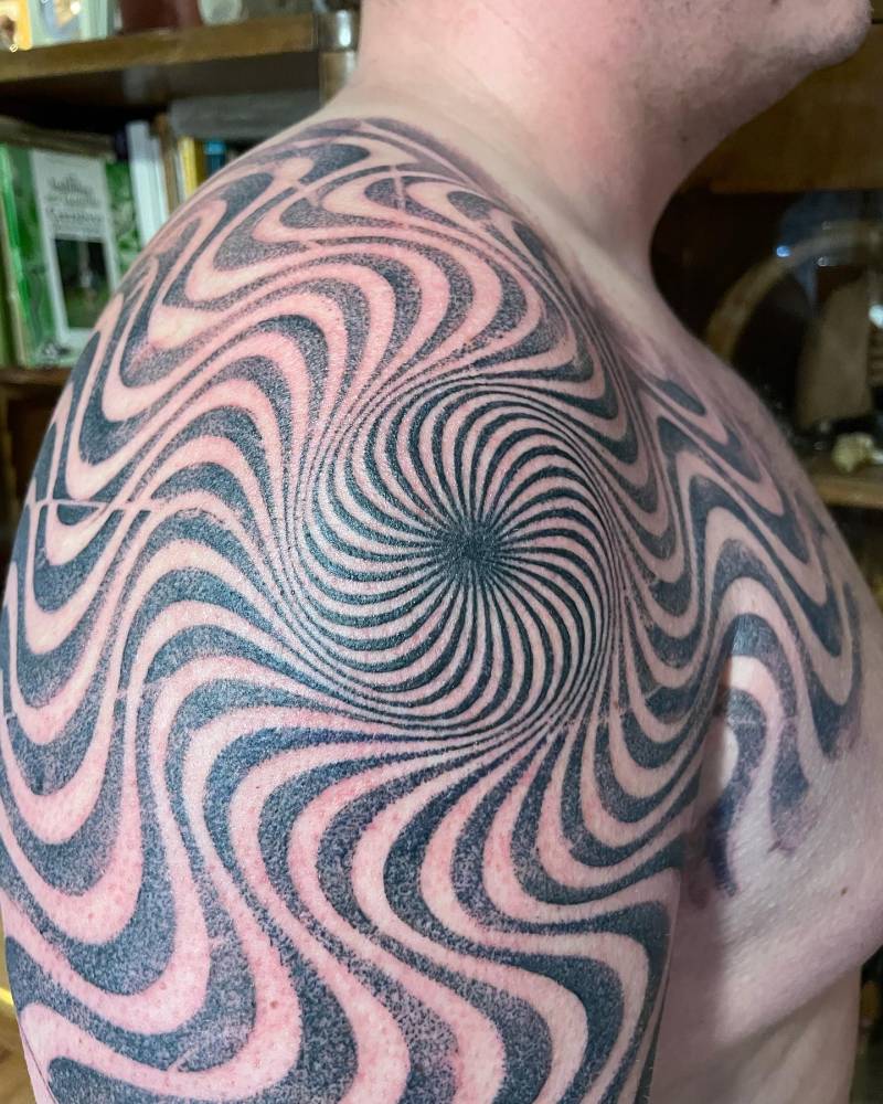 Optical illusion tattoo located on the shoulder.