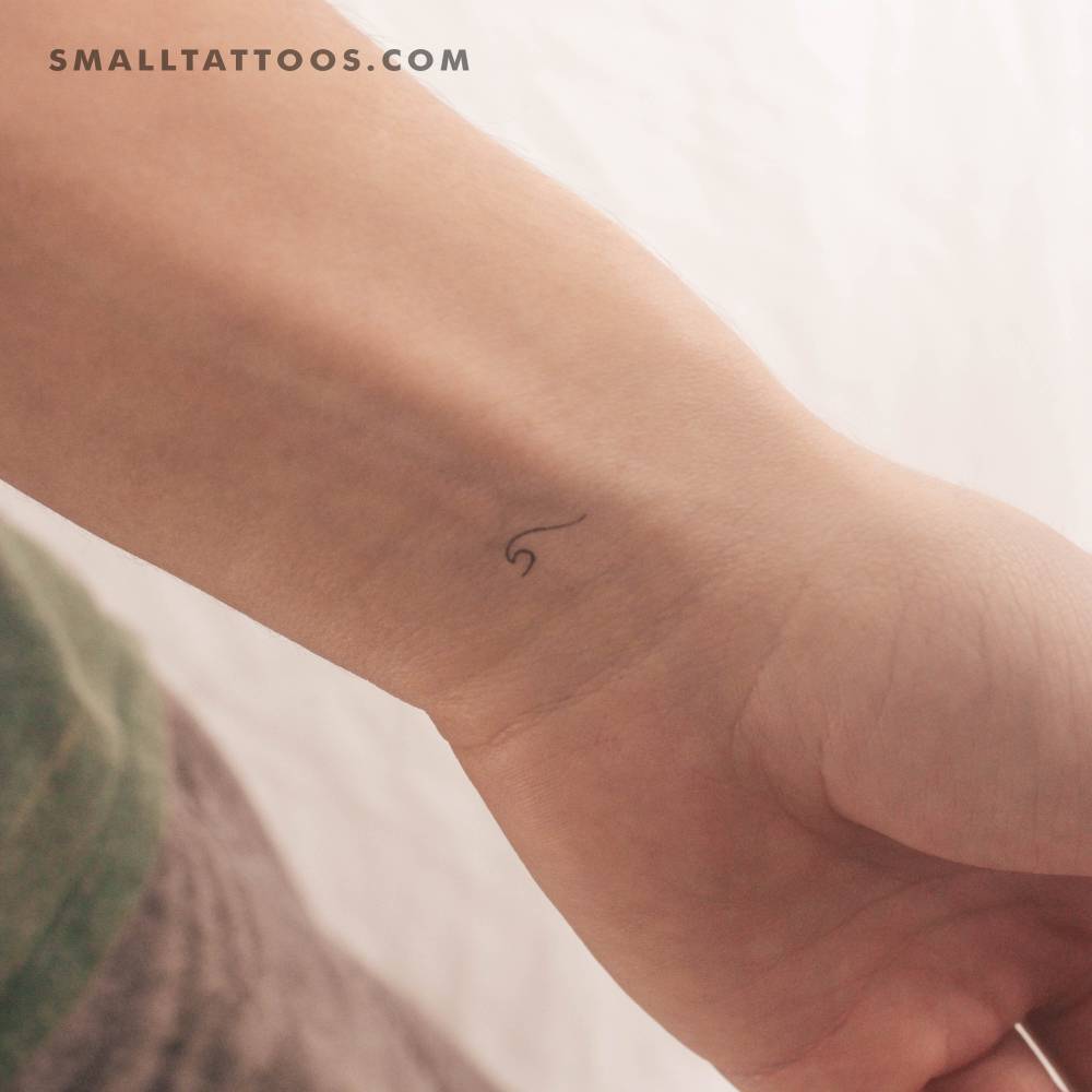 Tiny minimalistic wave temporary tattoo placed on the wrist.
