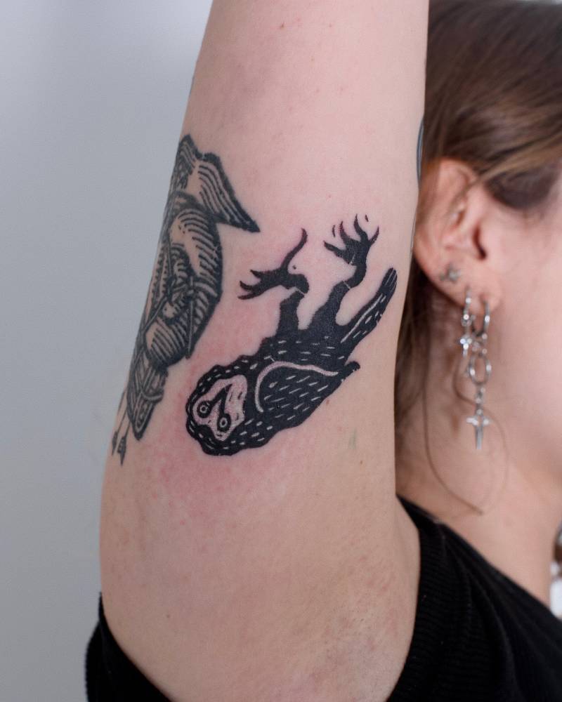 Blackwork style owl tattoo located on the inner arm.