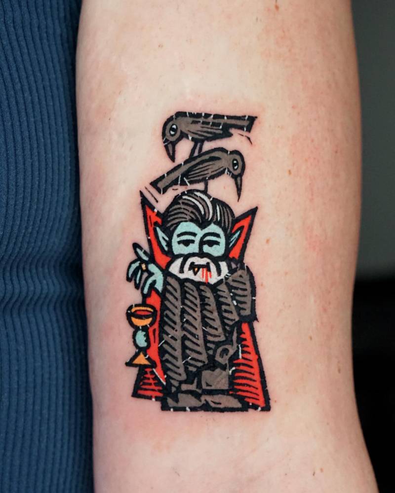 Dracula gnome tattoo in cartoon style done on the bicep.