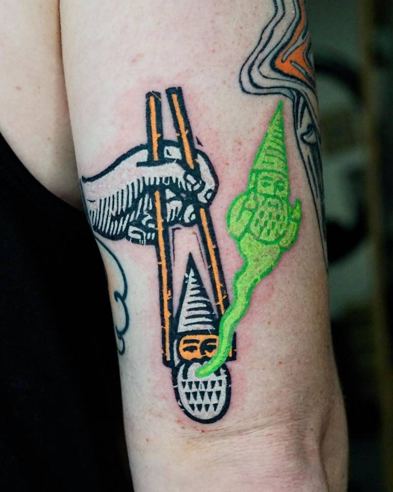 Nigiri sushi gnome tattoo located on the tricep, pop art style.