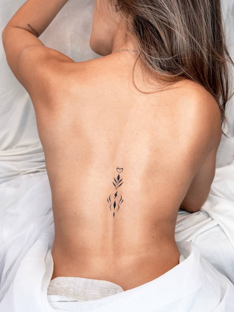 Blackwork style ornamental tattoo located on the back.