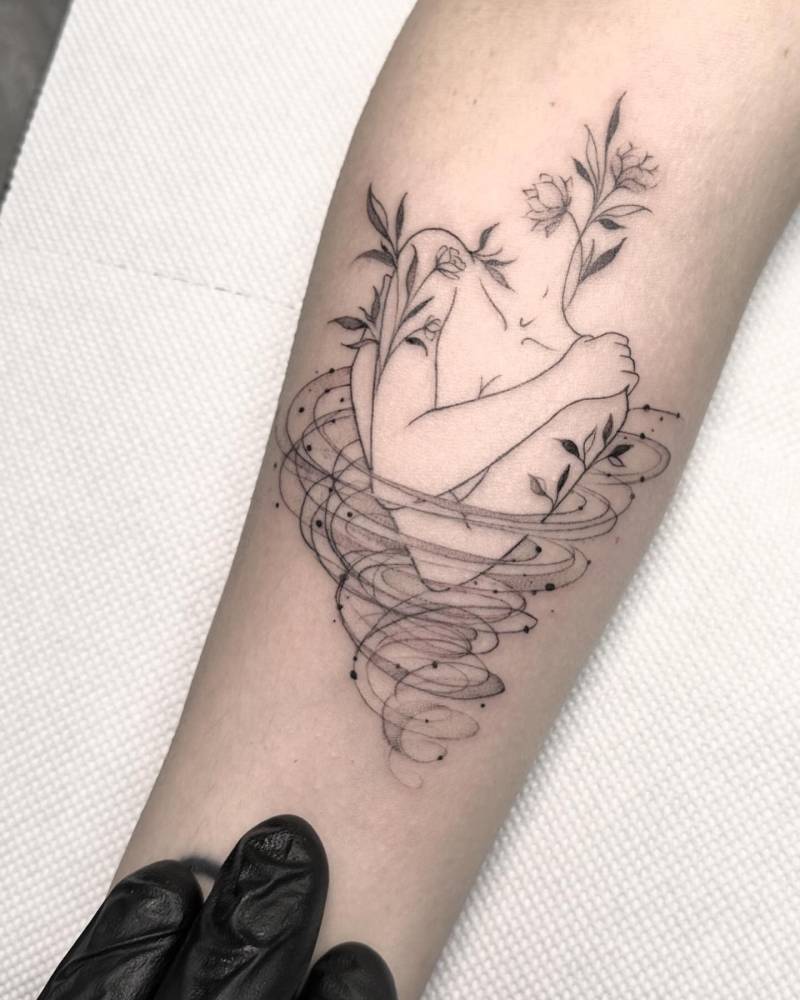 Self hug tattoo in illustrative style located on the inner forearm.