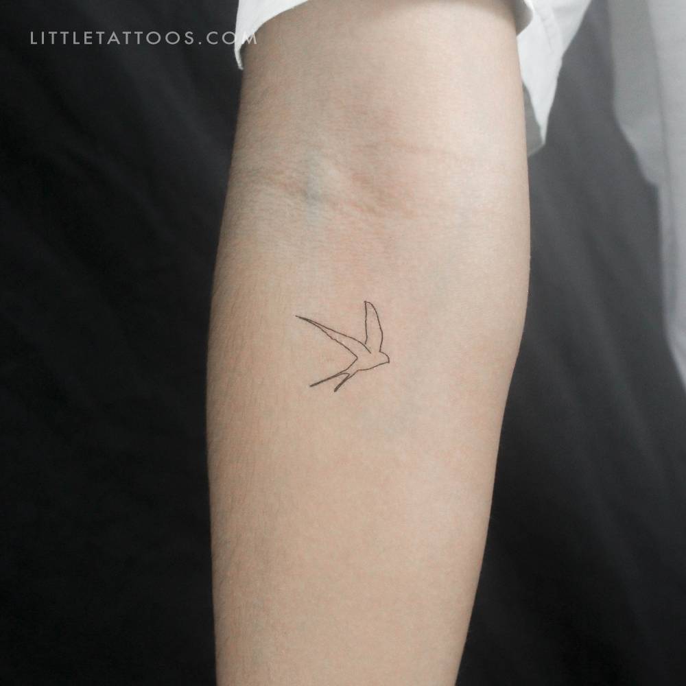 Continuous line swallow temporary tattoo located on the inner forearm.