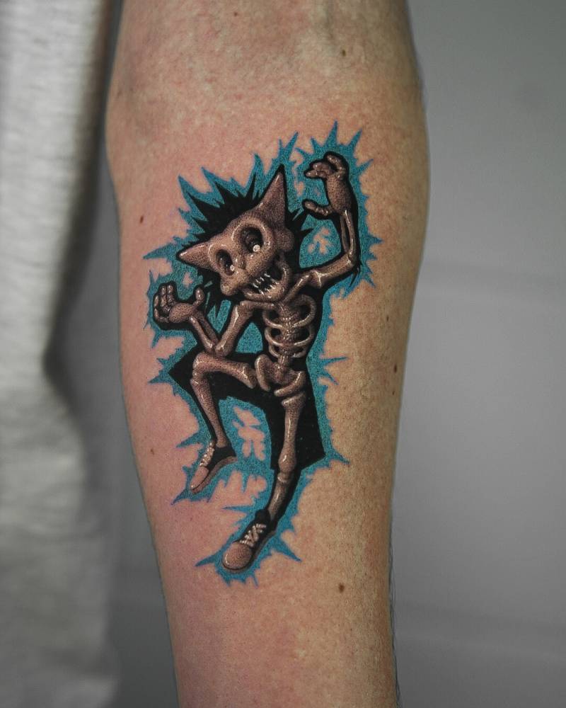 Cartoon style cat x-ray tattoo located on the inner forearm.