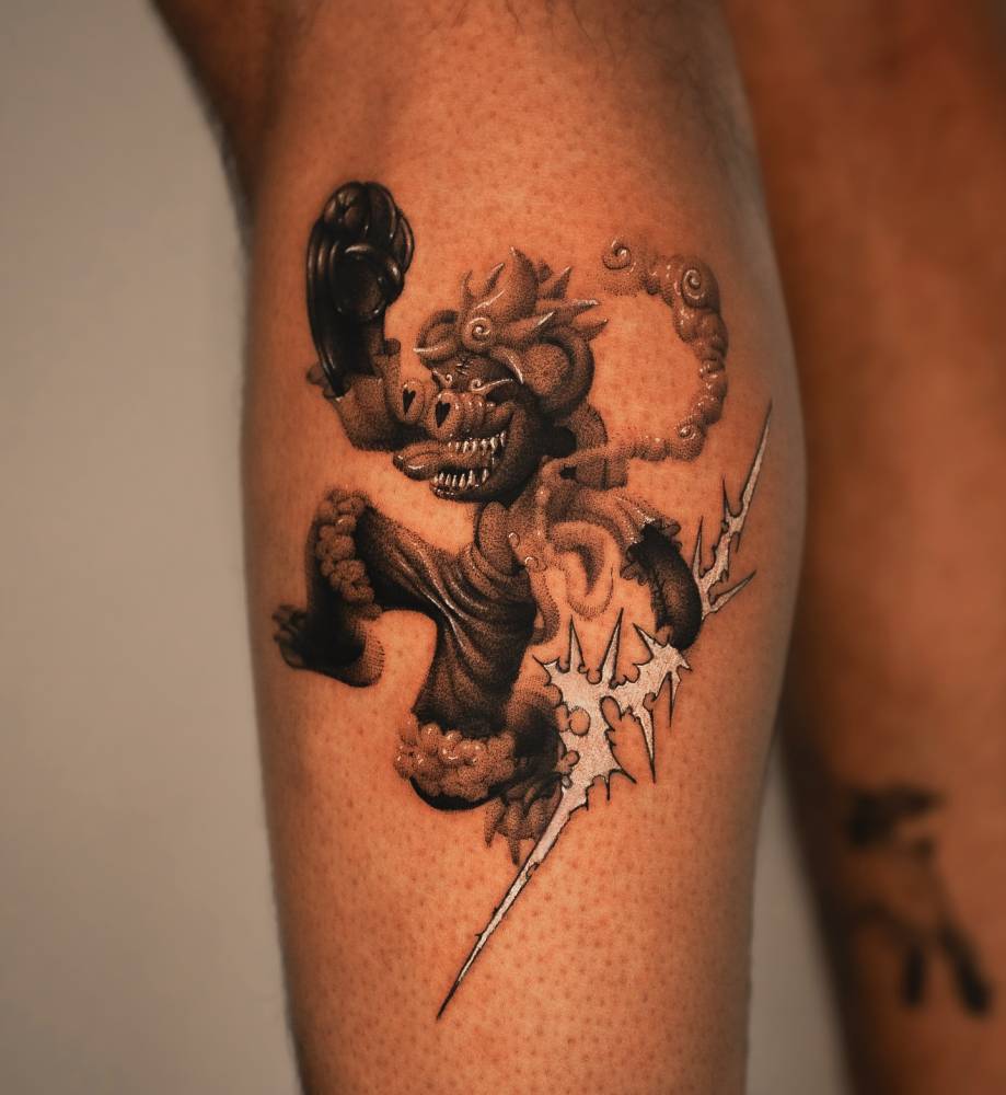 Nika tattoo located on the calf, done in cartoon style.