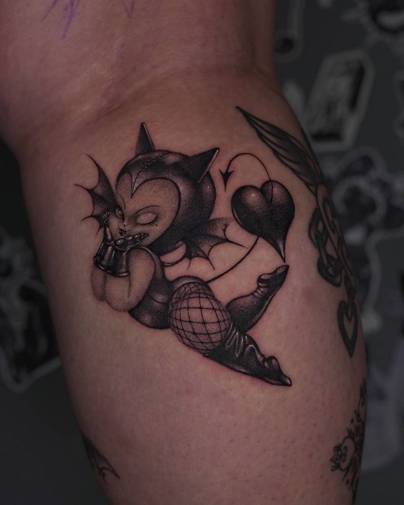 Kewpie she-devil tattoo in cartoon style placed on the calf.