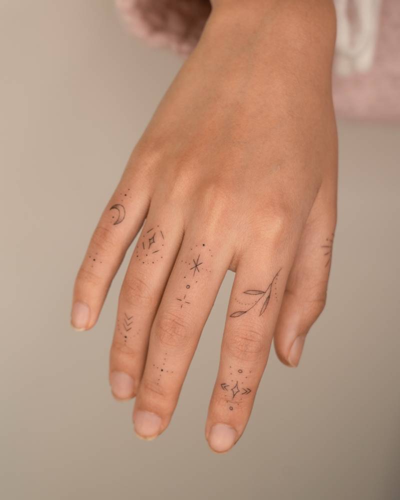 Finger composition tattoos in fine line style.