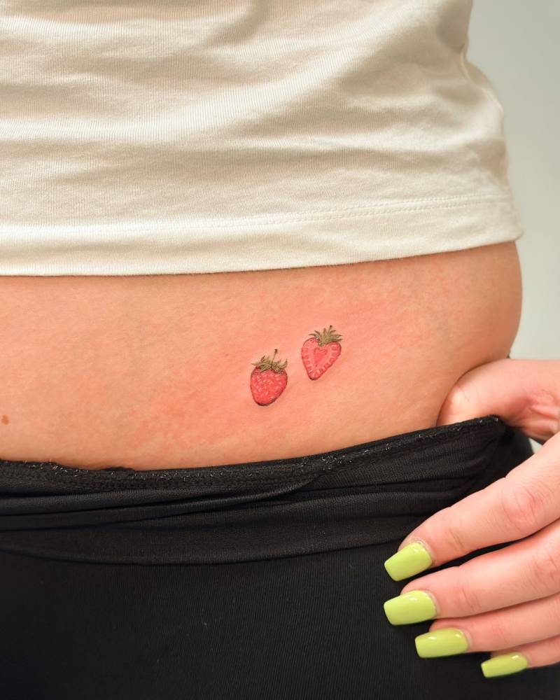 Illustrative style strawberries tattoo located on the waist.