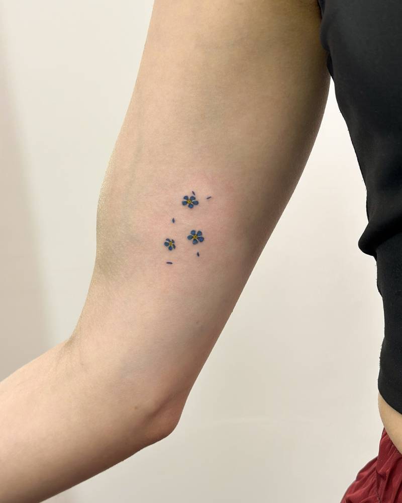 Tiny forget-me-not tattoo placed on the inner arm.
