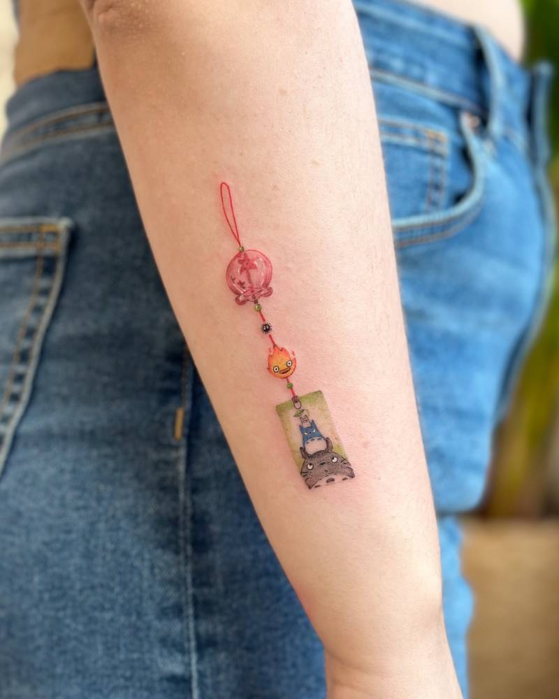 Studio Ghibli Norigae tattoo located on the forearm.