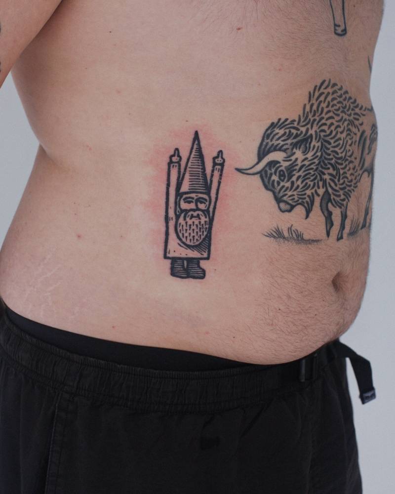 Pop art style gnome tattoo located on the waist.