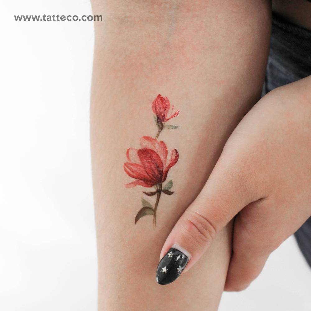 Watercolor style magnolia temporary tattoo placed on the inner forearm.