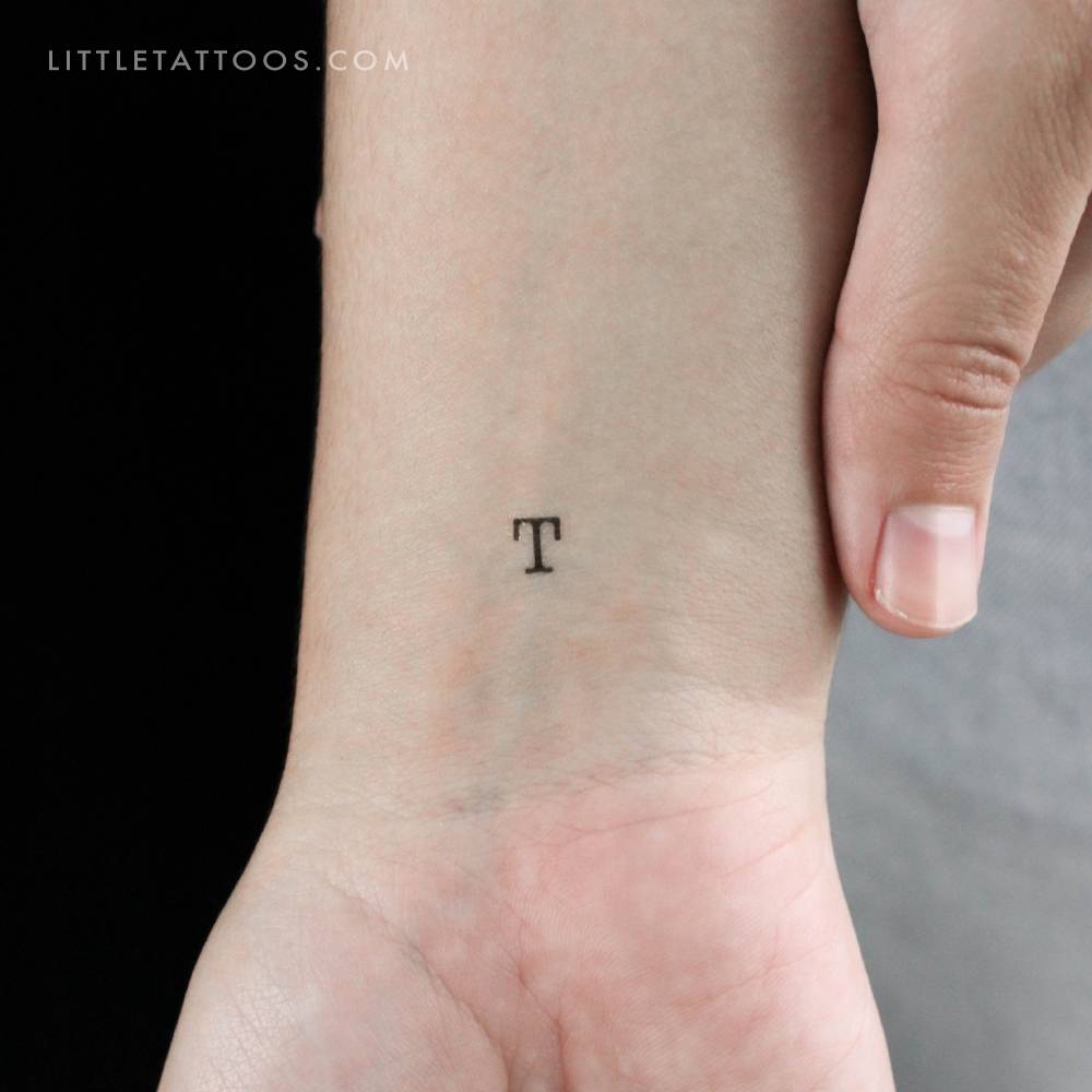 T uppercase typewriter letter temporary tattoo located on the wrist.