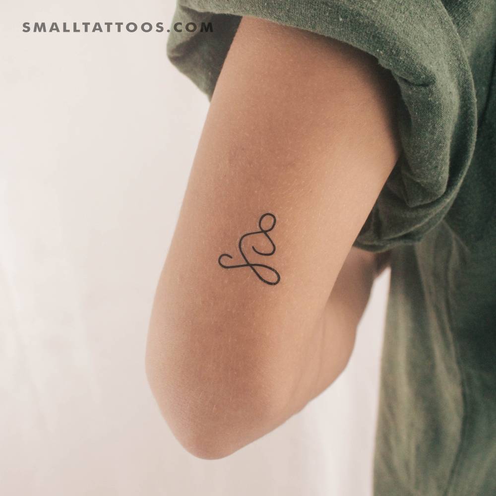 Minimalist meditator temporary tattoo located on the tricep.