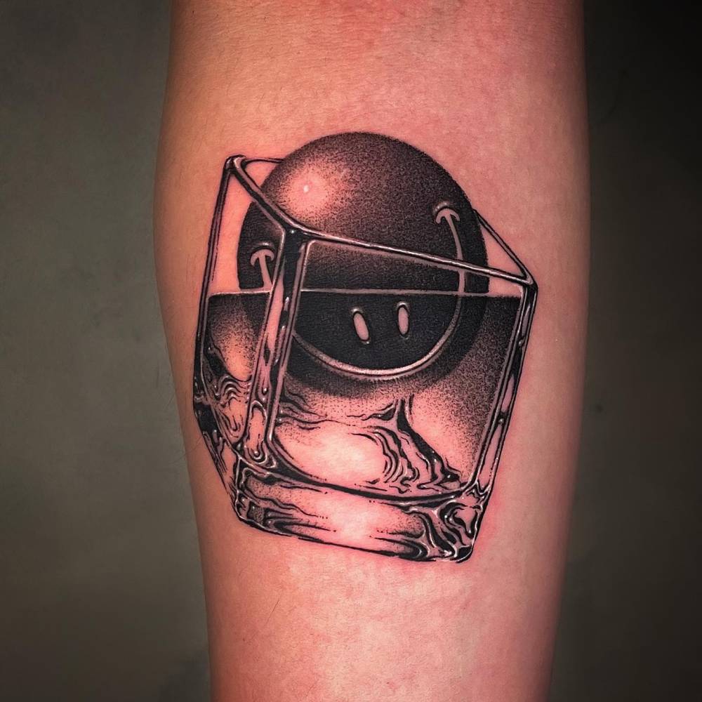 Smiley cocktail tattoo located on the inner forearm.