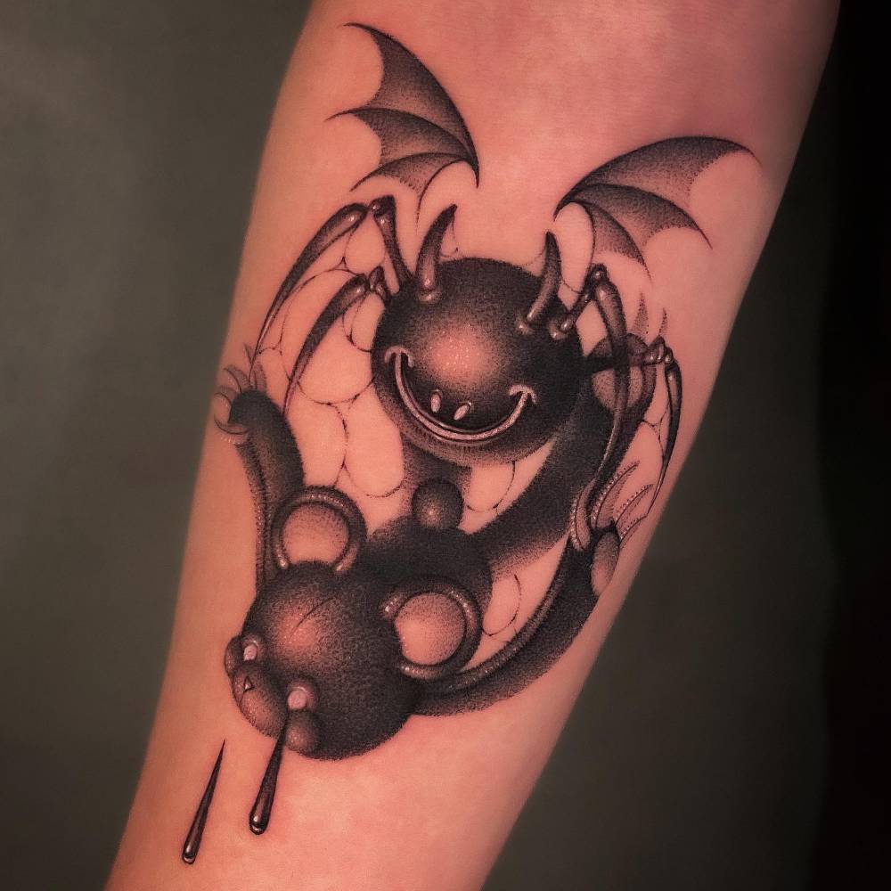 Smiley spider and teddy bear tattoo in dotwork style located on the inner forearm.