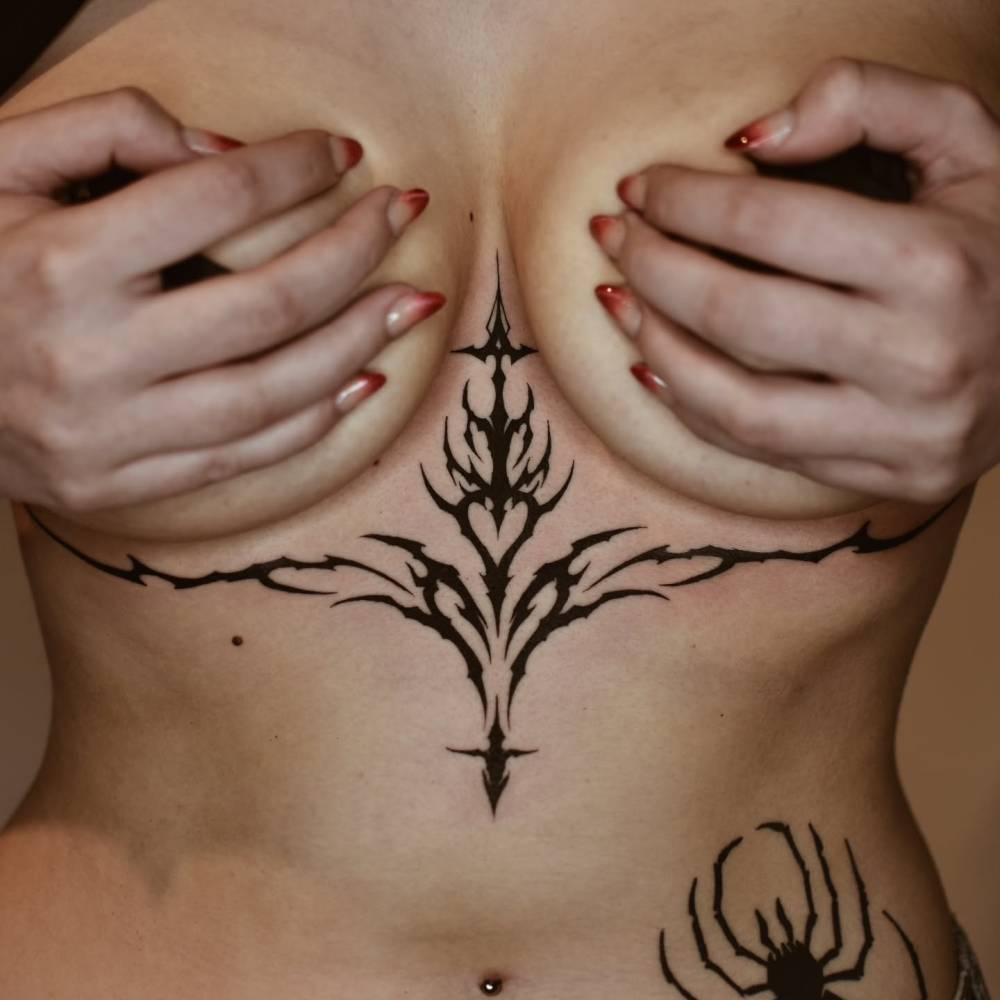 Tribal design tattoo in blackwork style.