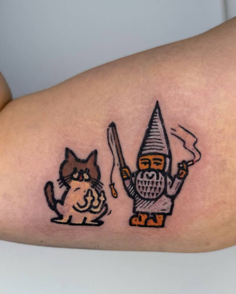 Gnome and cat tattoo in pop art style located on the inner arm.
