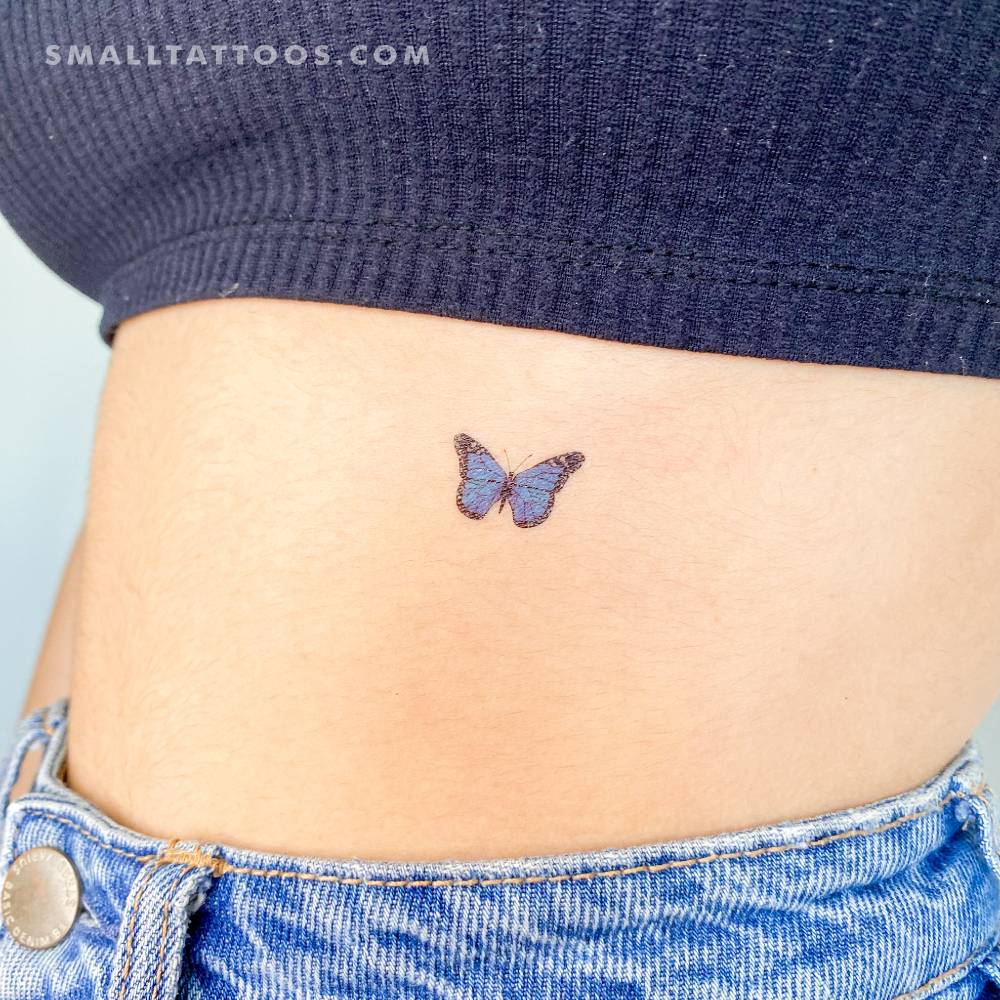 Small blue butterfly temporary tattoo located on the rib.