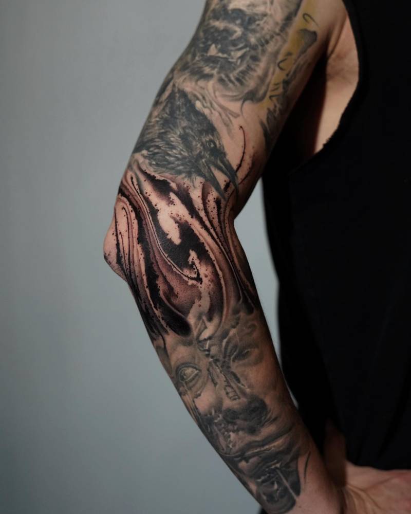 Blackwork style abstract design tattooed on the elbow.