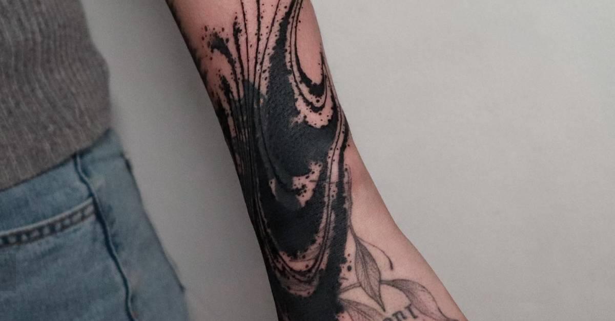 Abstract cover up design tattooed on the wrist.