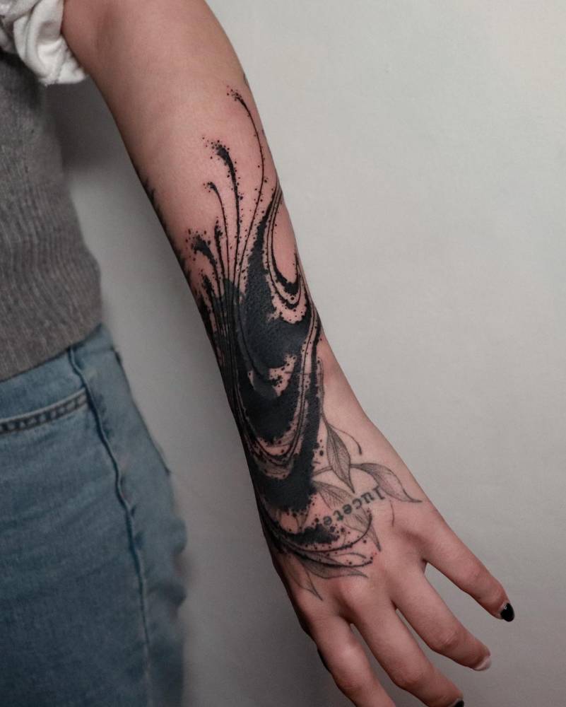 Abstract cover up design tattooed on the wrist.