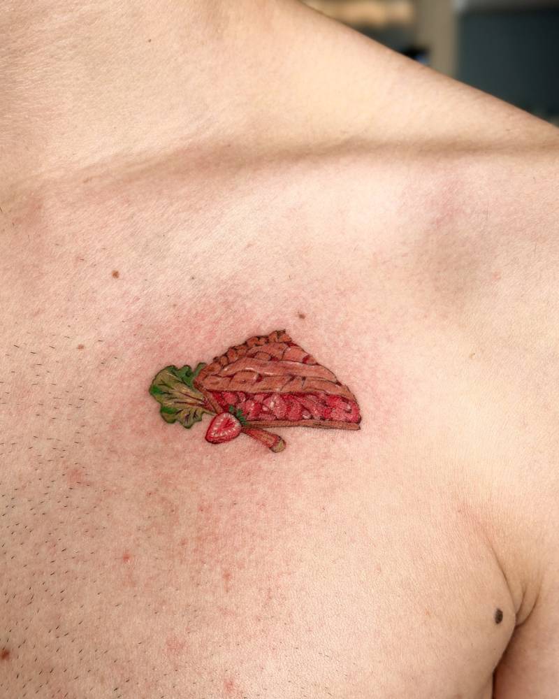 Illustrative style pie tattoo located on the chest.
