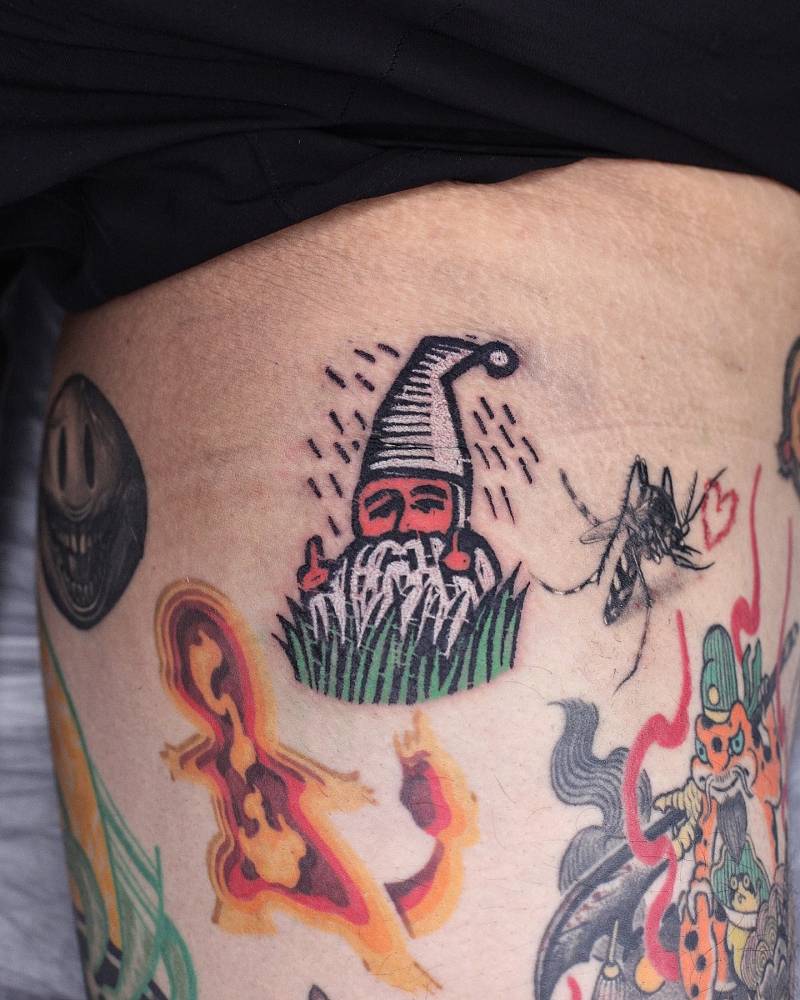 Gnome tattoo in pop art style located on the inner arm.