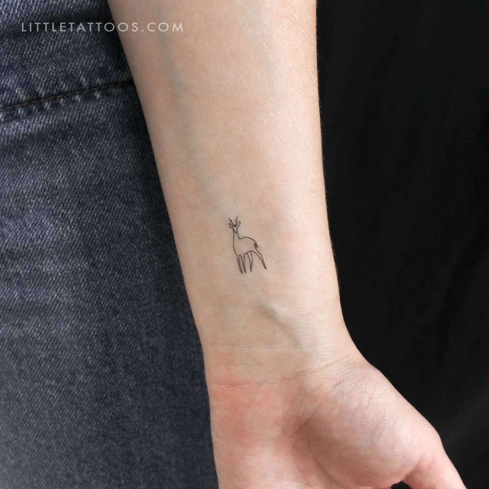 Fine line style minimalistic deer temporary tattoo placed on the wrist.