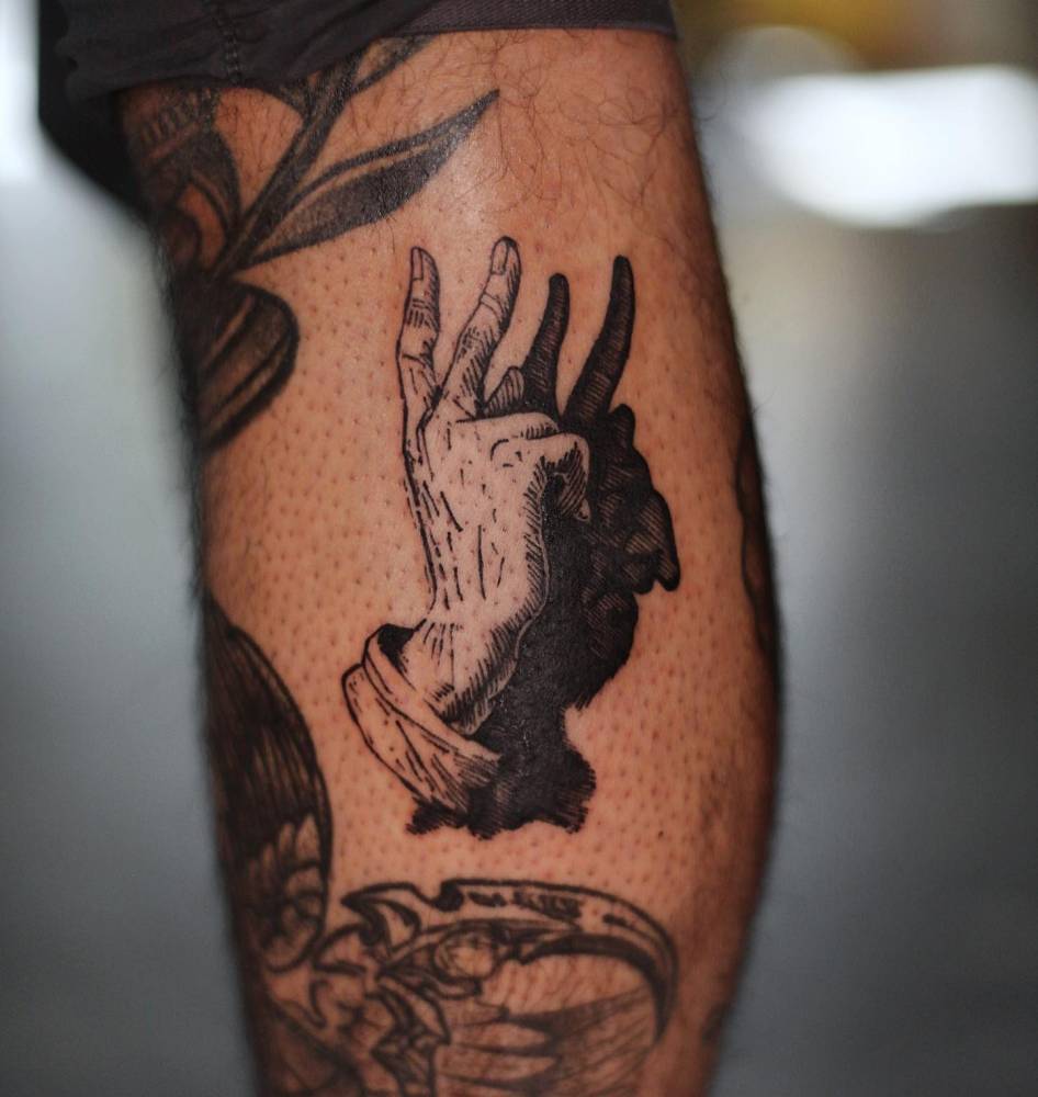 Shadowgraphy tattoo in blackwork style located on the calf.