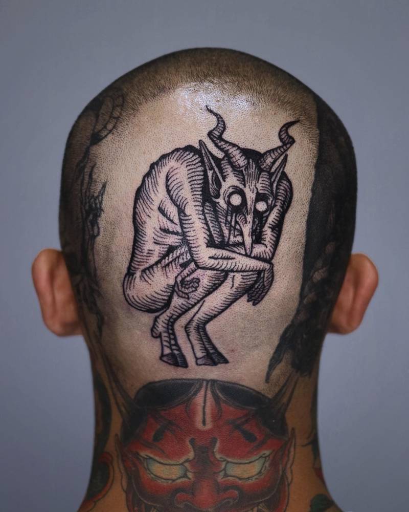 Devil tattoo in engraving style done on the back of the head.