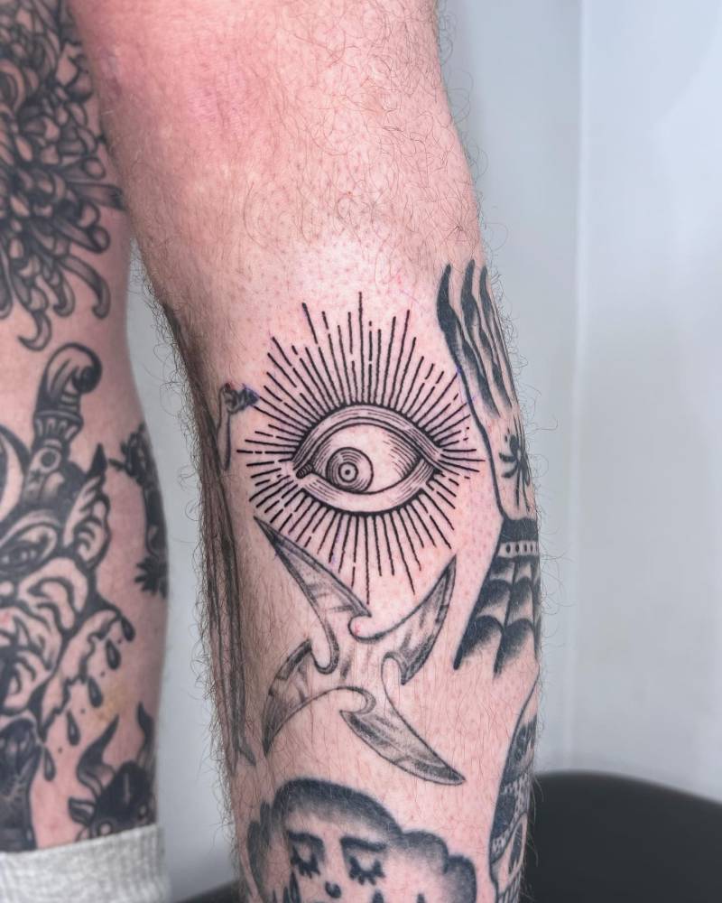 Eye gap filler tattoo in engraving style located on the shin.