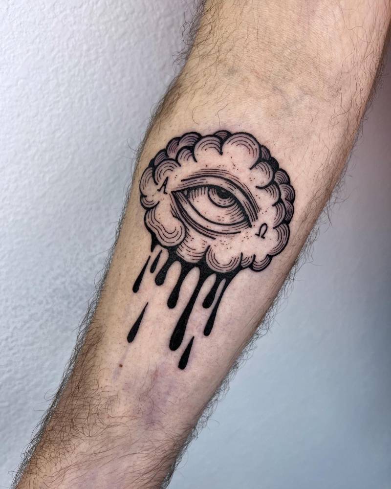 Crying cloud tattoo located on the inner forearm, engraving style.