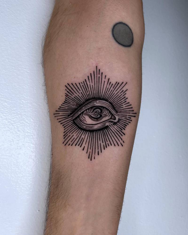 Eye in engraving style tattooed on the inner forearm.